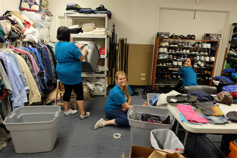 Organizing the room full of interview-ready clothing at PADS of Elgin.