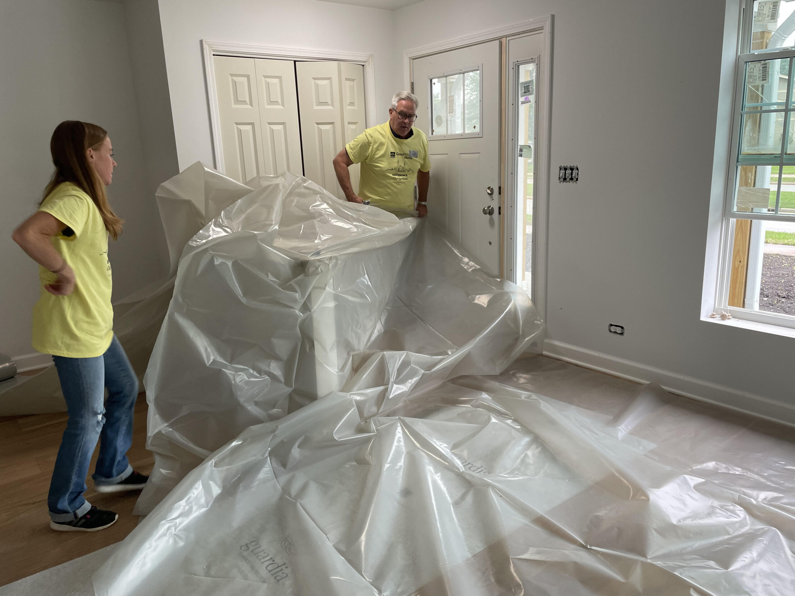 Laying down tarp  for painting for Habitat for Humanity in Hanover Park